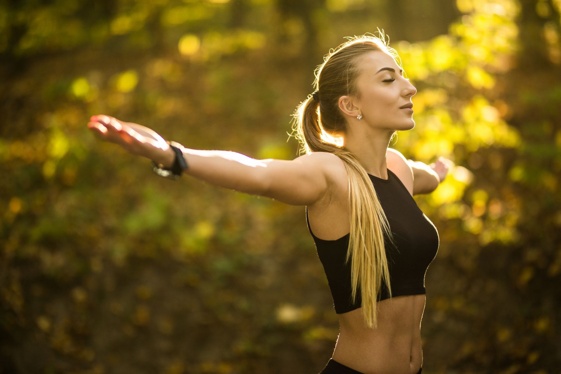 Woman doing yoga outdoors in a park