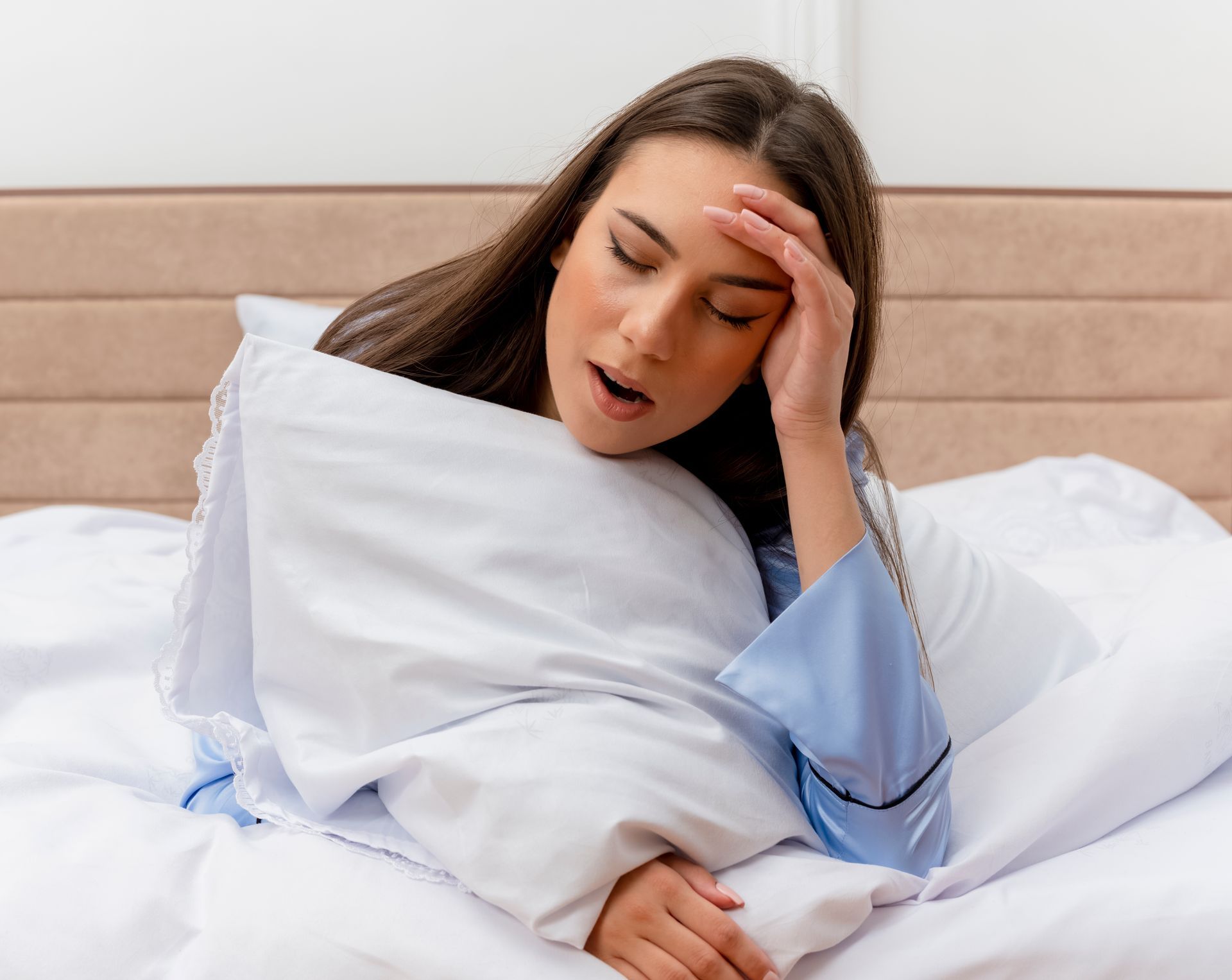 Woman waking with a headache in need of hydration