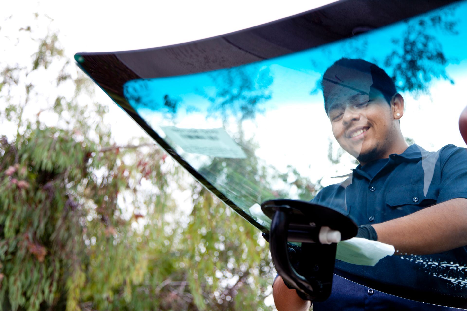 Man repairing and replacing the glass on a car - Auto Glass Repair in Omaha, NE