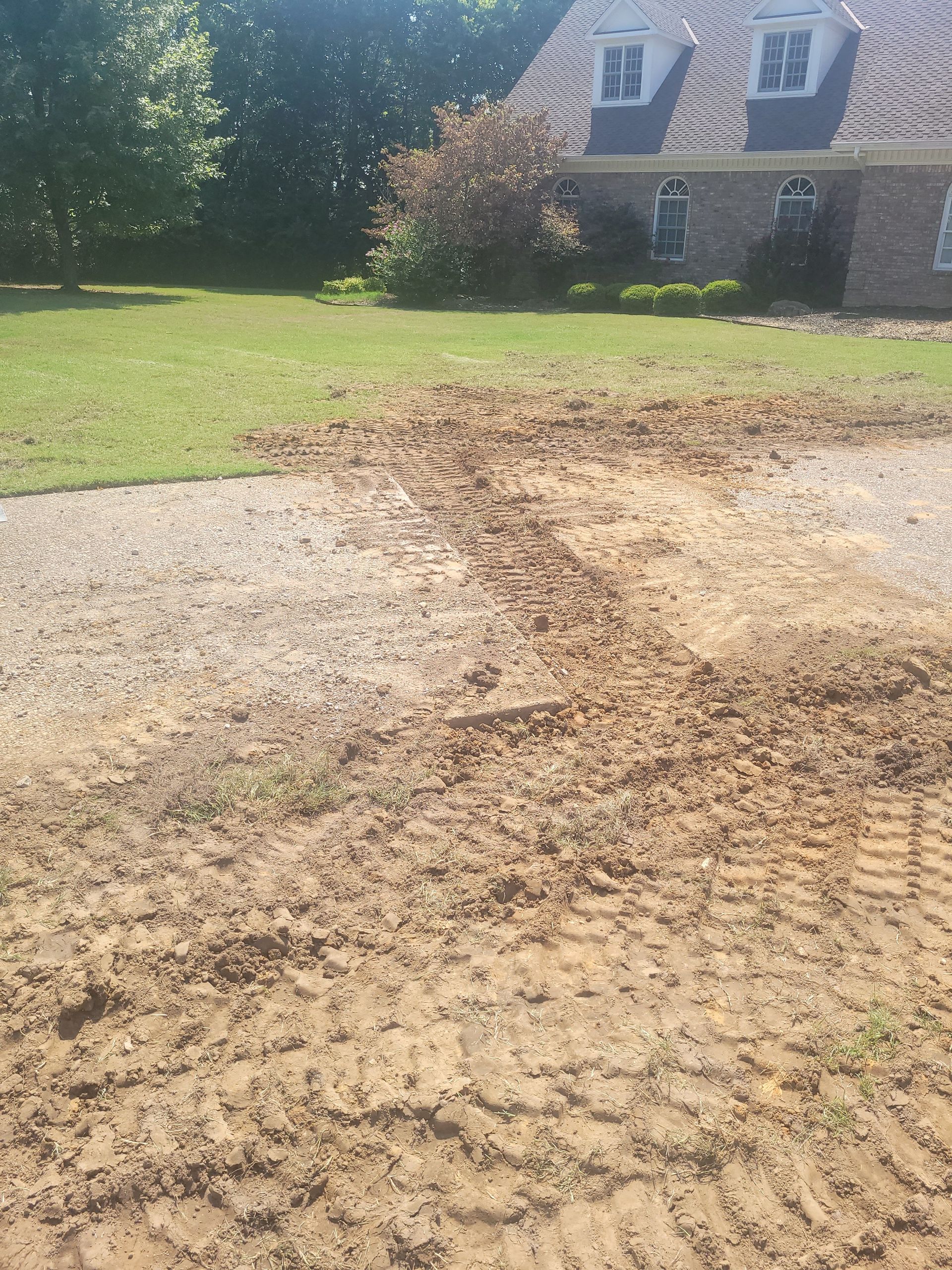 A house with a lot of dirt in front of it