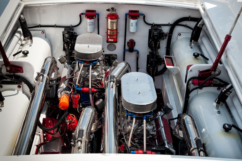 Two Boat Engines in an Engine Bay With Pipes, Filters, and a Fire Extinguisher — Pete's Auto Electrical in Cranbourne, VIC