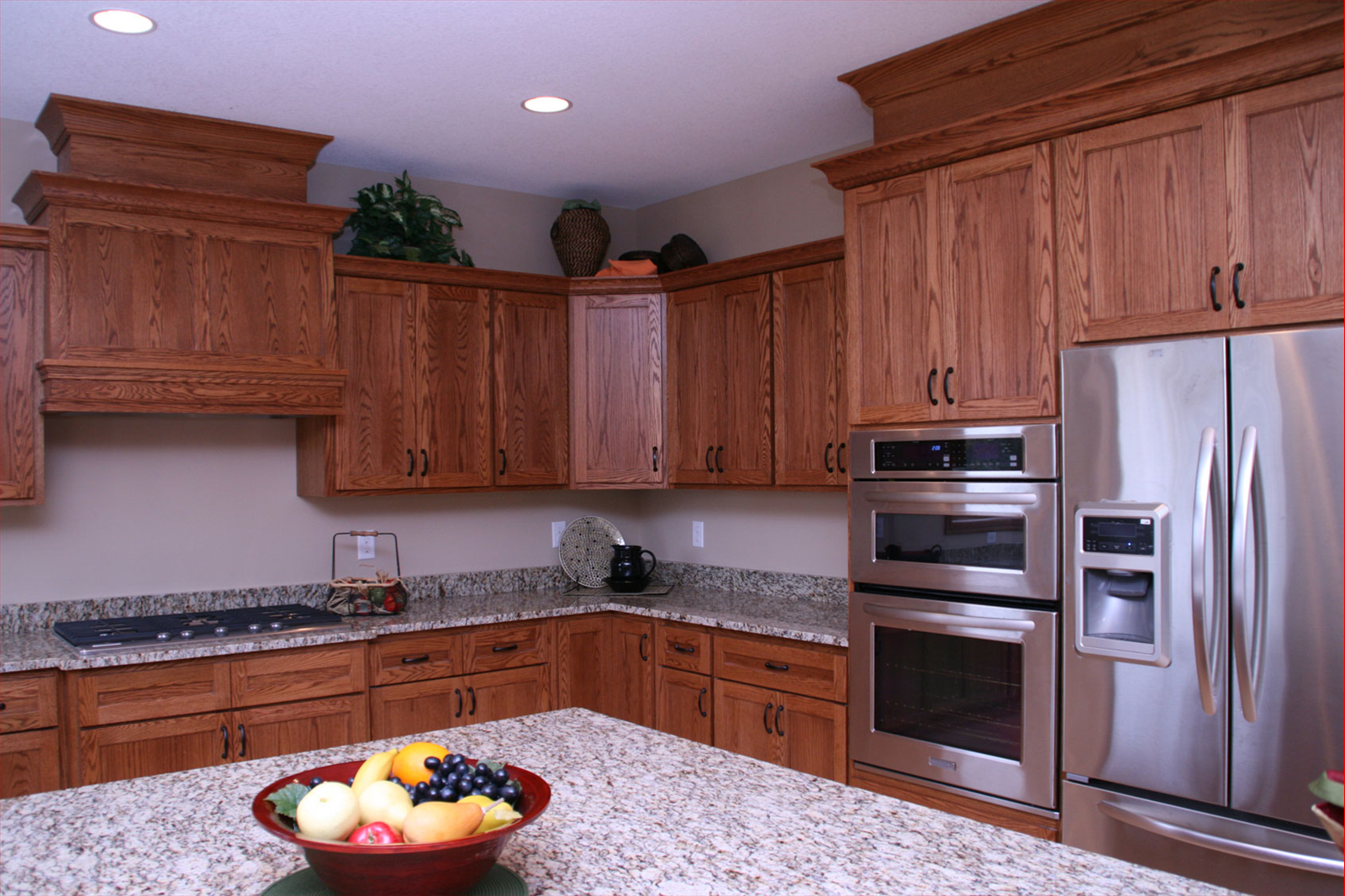 Kitchen with wooden cabinets, granite countertops, and stainless steel appliances.