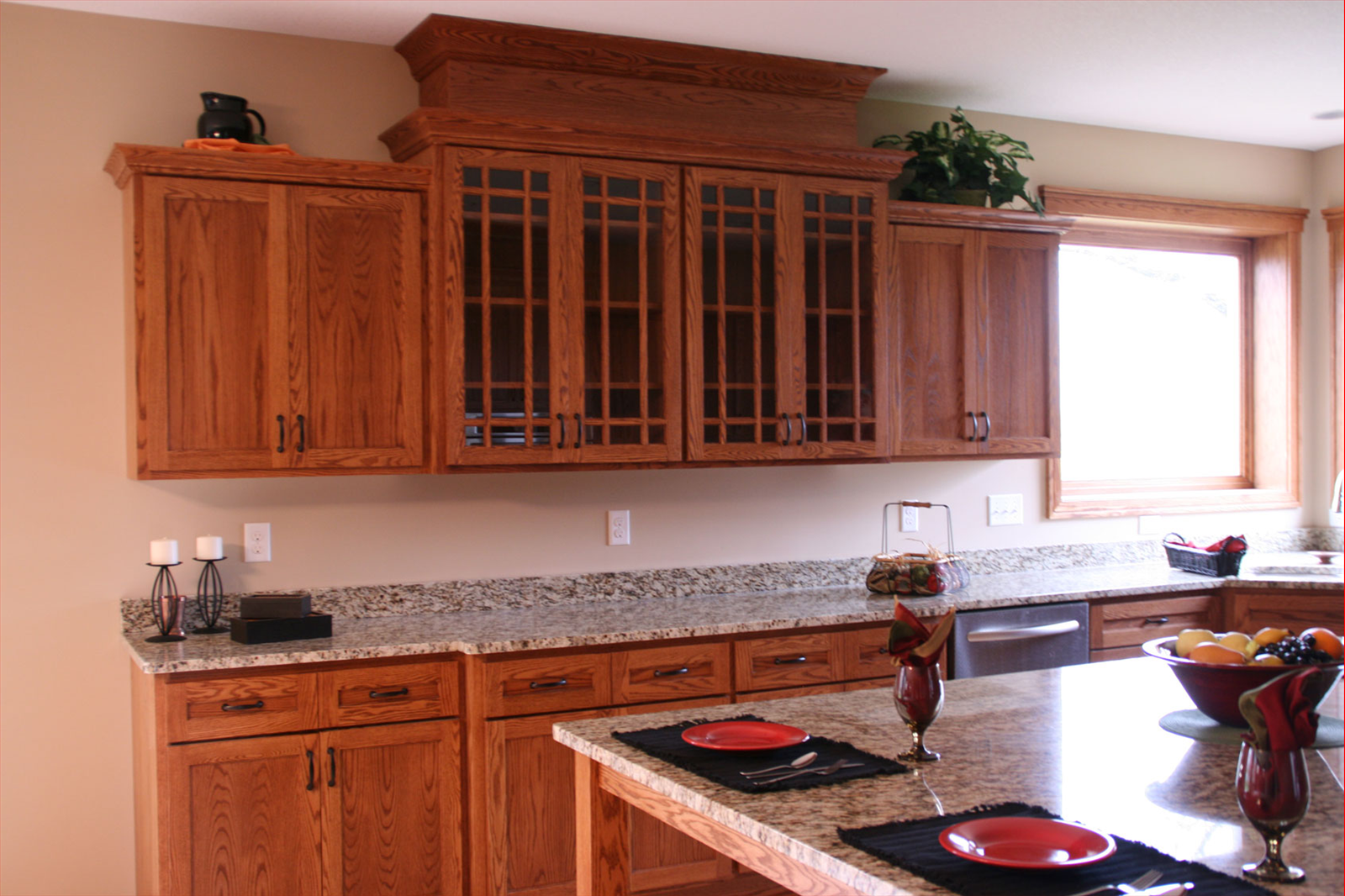 Kitchen with wooden cabinets, granite countertops, and a center island.
