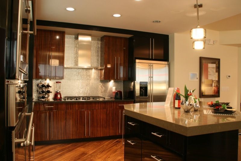 Modern kitchen with wood cabinets, stainless steel appliances, and a central island.