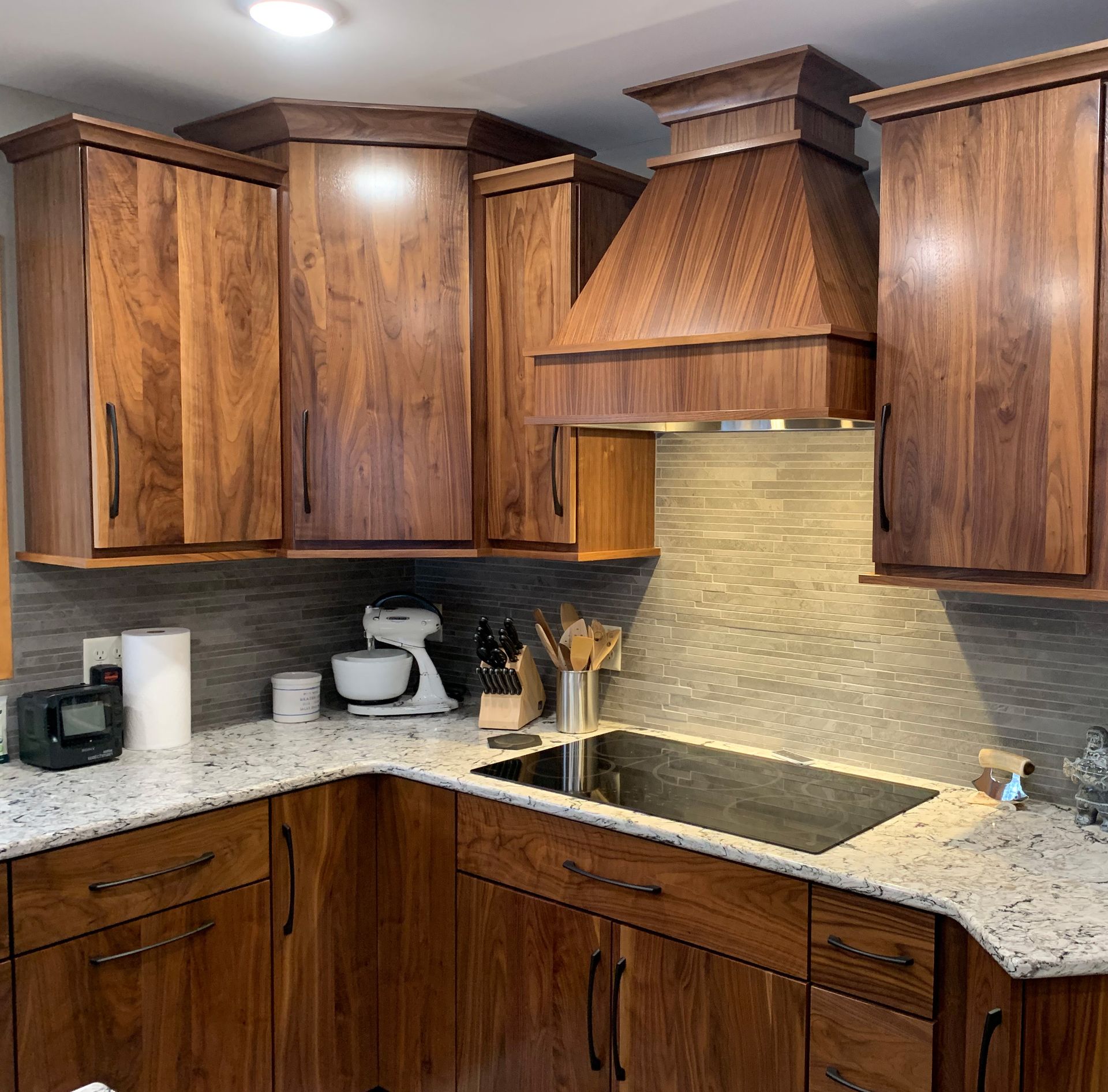 Kitchen with dark wood cabinets, granite countertops, and stainless steel appliances.