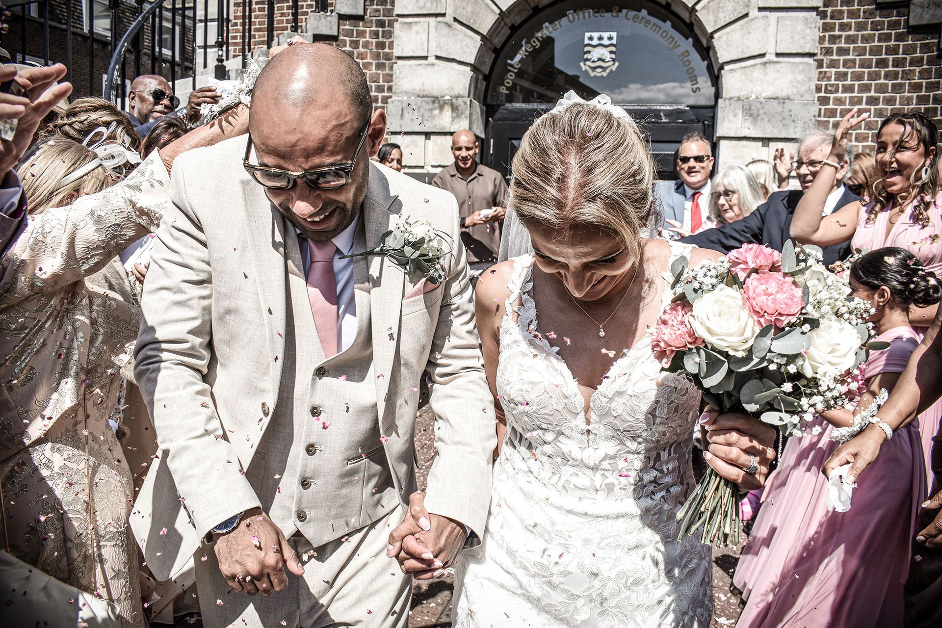 bride and groom greeted by guests at their wedding at poole register office poole bournemouth