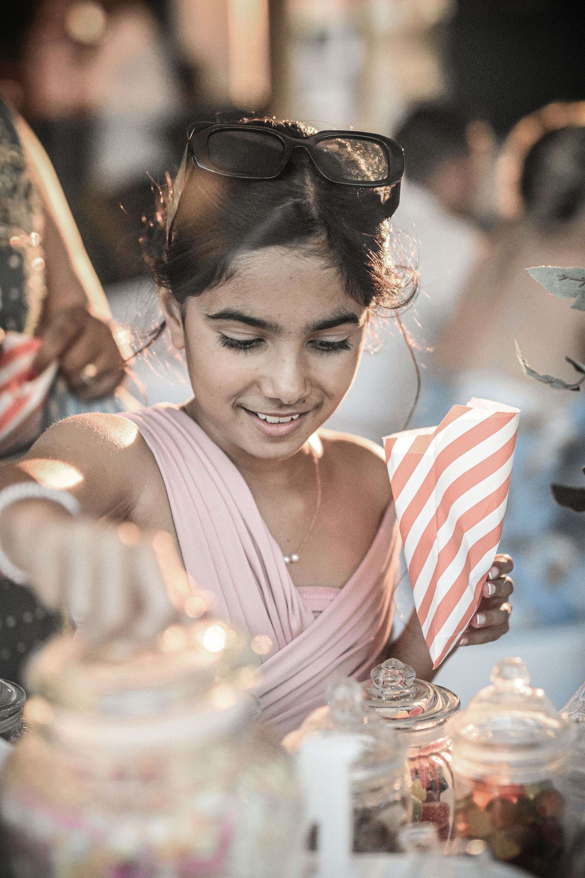 photograph of bridesmaid choosing sweets at wedding reception bournemouth poole