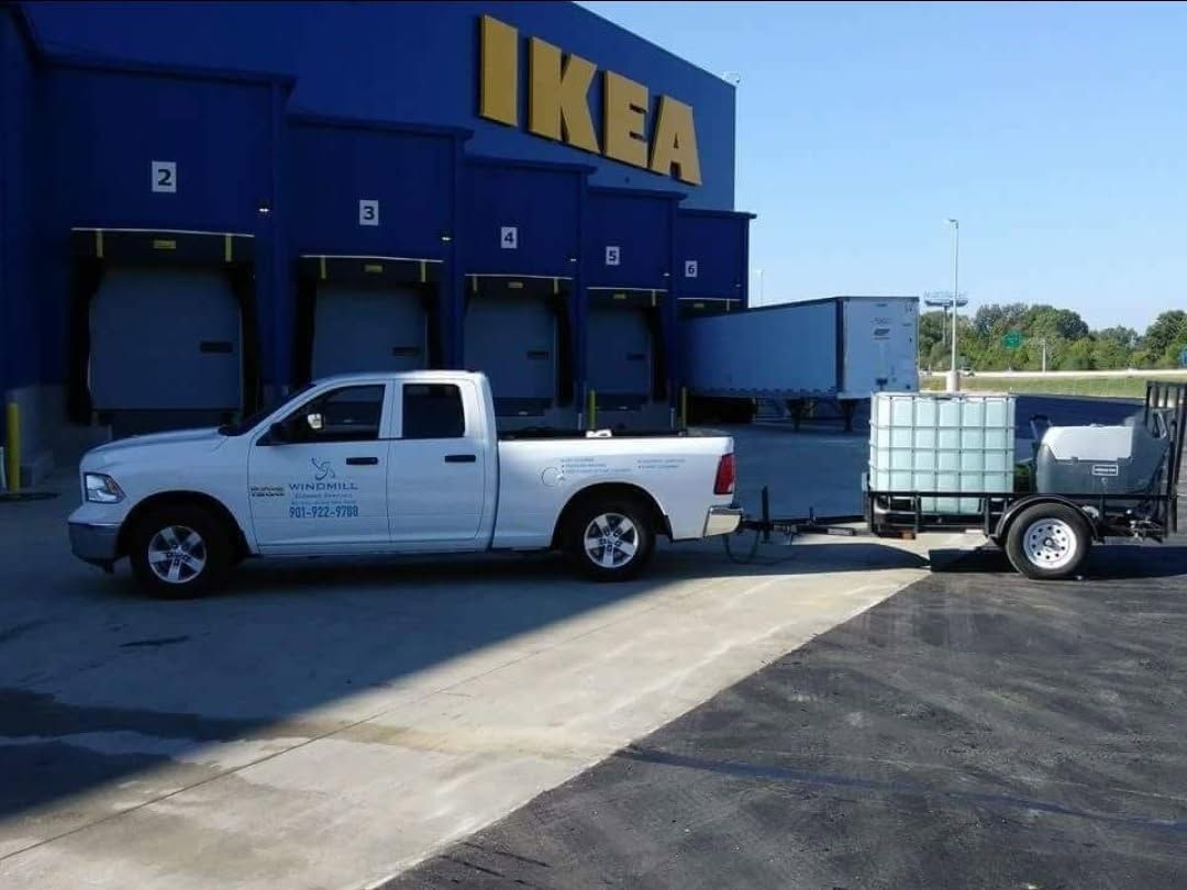 A white truck is parked in front of an ikea store