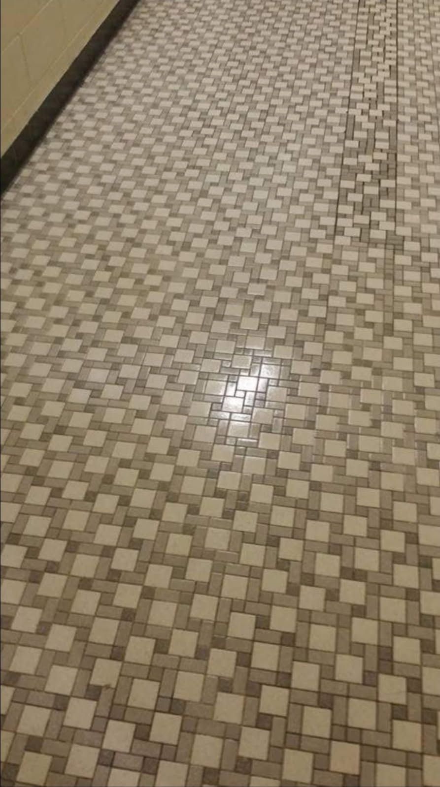 A close up of a tiled floor in a hallway.