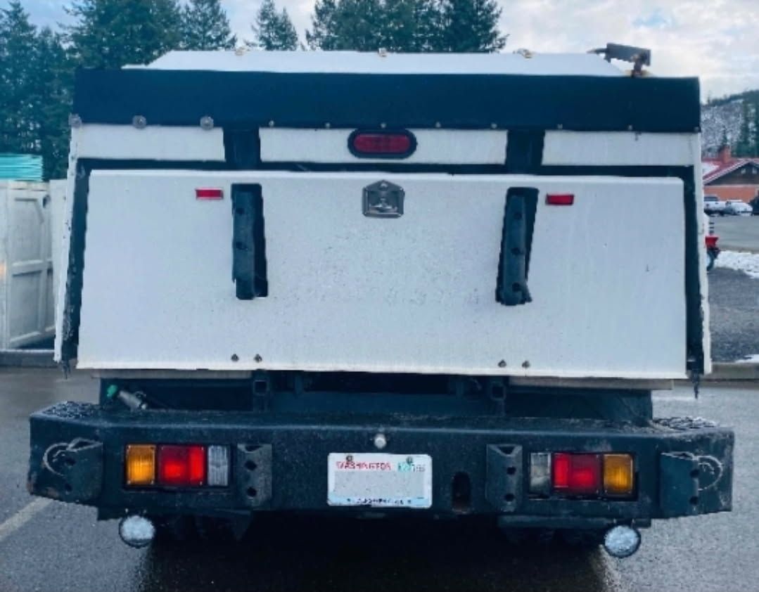 A black and white truck with a license plate that says washington