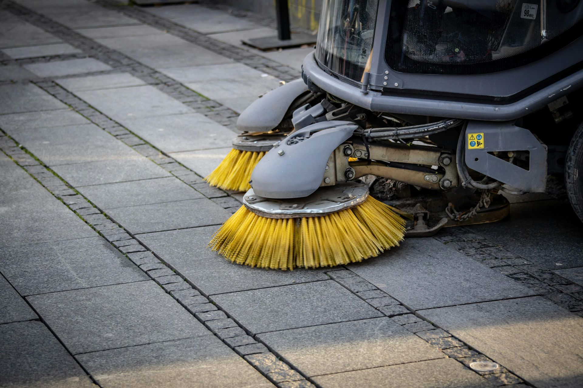 A group of cleaners standing next to each other holding buckets and a vacuum cleaner.