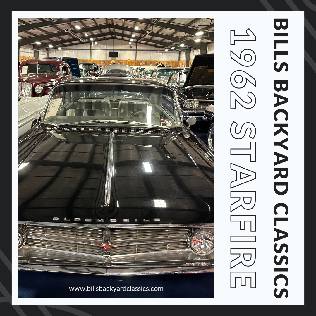 Black 1962 Oldsmobile Starfire. Car show. 