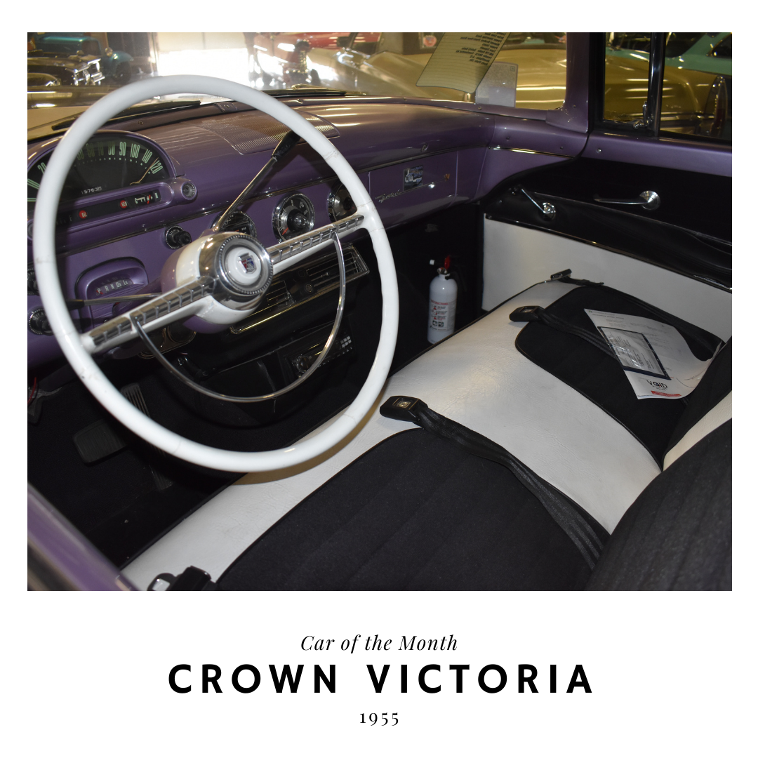 Interior of a purple and white 1955 Crown Victoria car. Features a white steering wheel and two-tone seating.