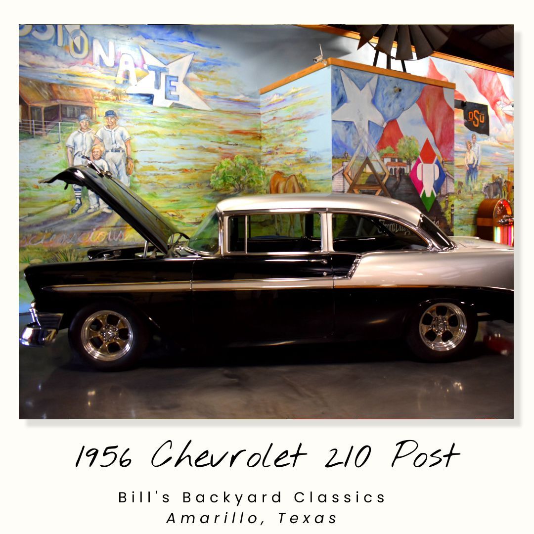 1956 Chevrolet 210 Post, black and silver, hood up, in front of a Texas-themed mural.