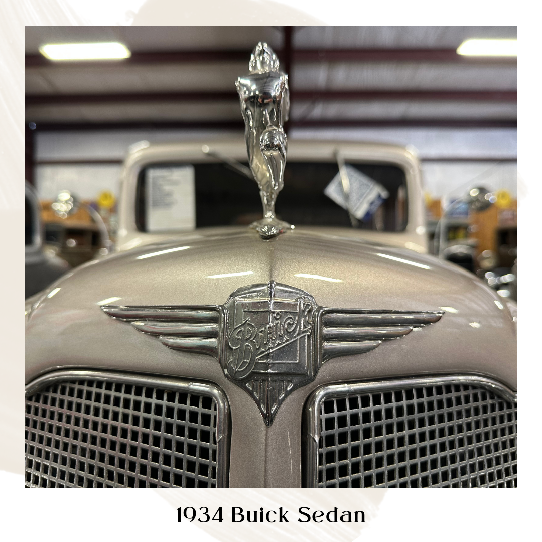 A close-up of a 1934 Buick Sedan's hood, showcasing the car's emblem and chrome hood ornament.
