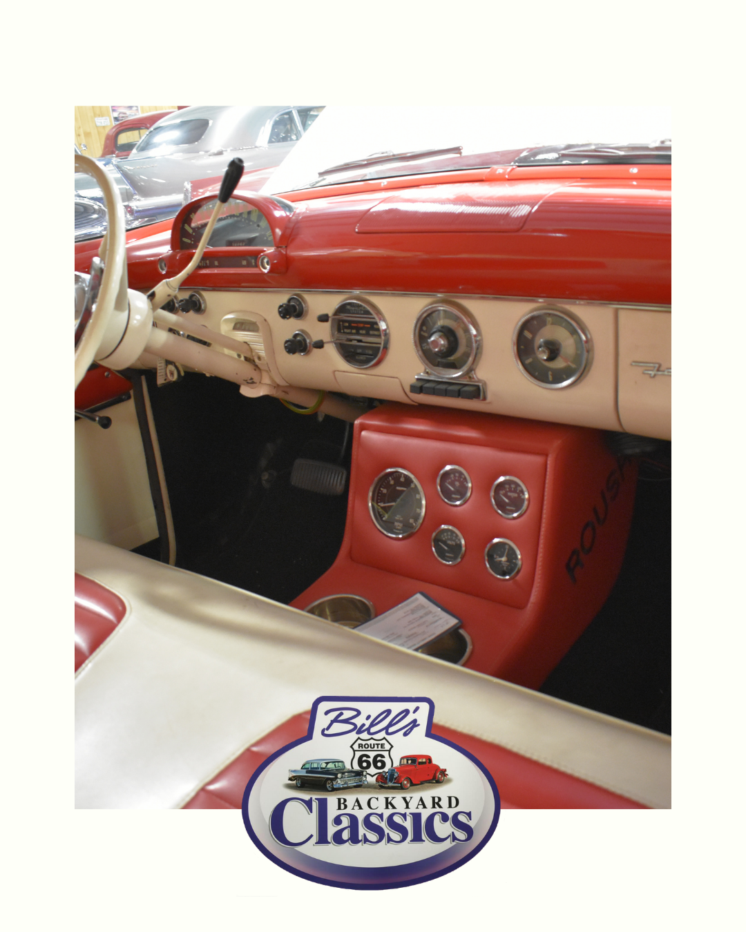 Red and cream vintage car interior. Dashboard with gauges, custom center console with cup holders.