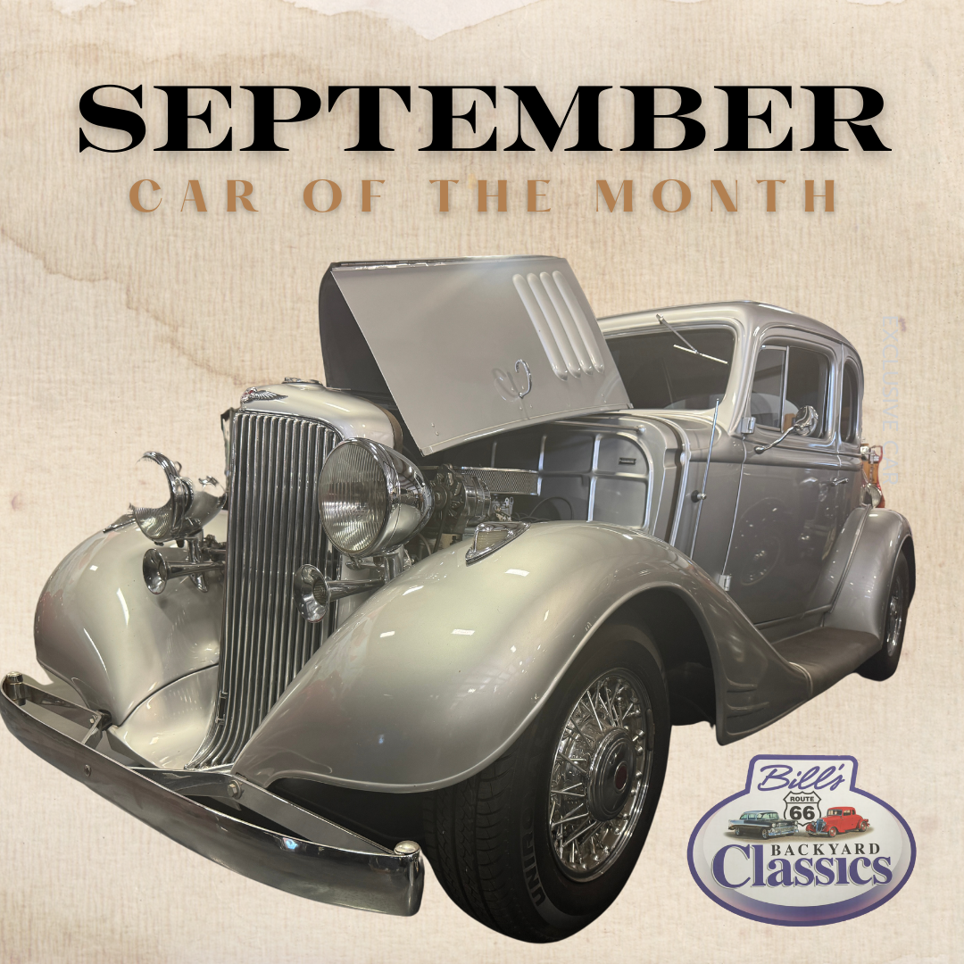 Silver classic car with the hood up, displayed as September’s 