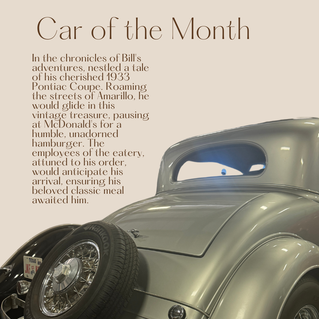 A silver 1933 Pontiac Coupe with text 