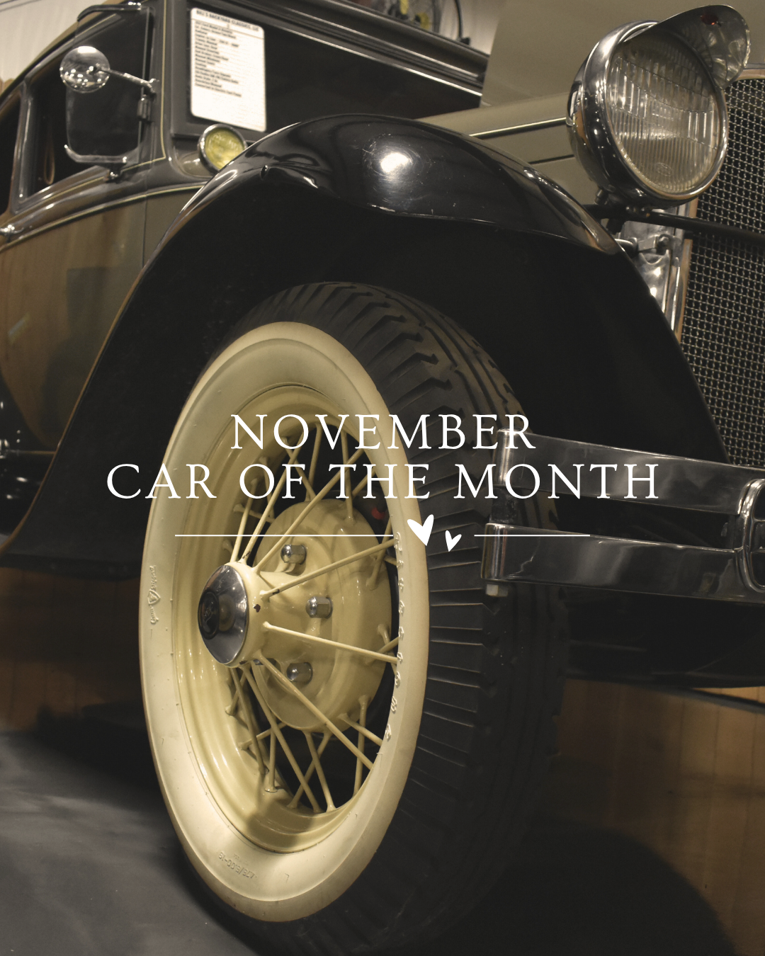 Close-up of a vintage black and brown car, white-walled tires, 