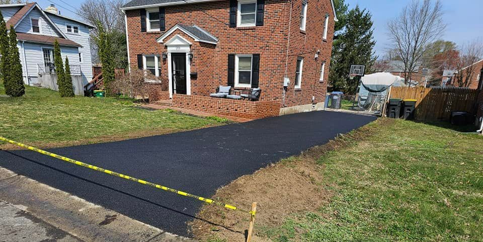A Brick House with A New Driveway in Front of It — New Castle, DE — Lopez General Contractors LLC