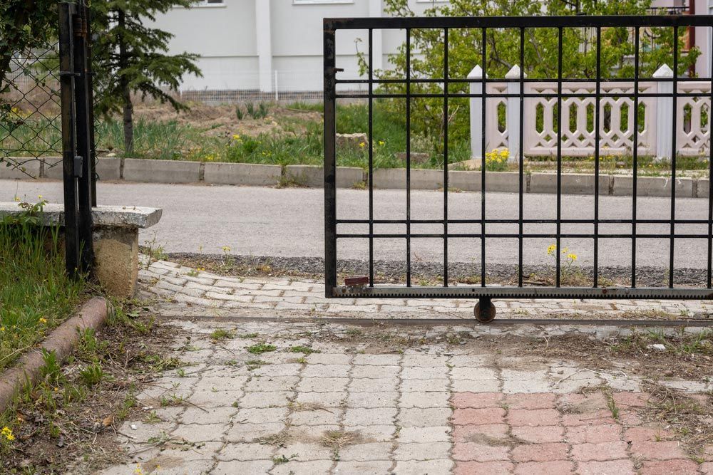 A Sliding Gate Is Open to A Brick Driveway — FBM Fabrication In Wollongong, NSW