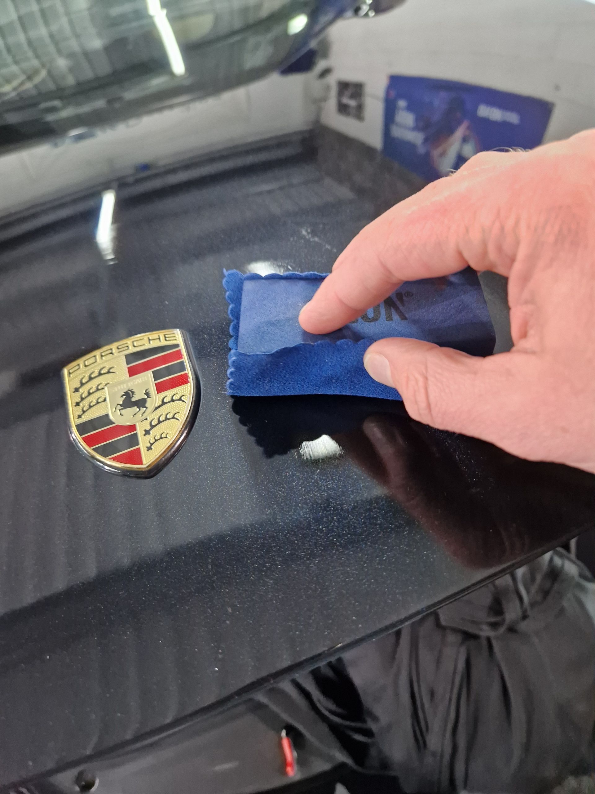 applying a ceramic coating on a black Porsche hood