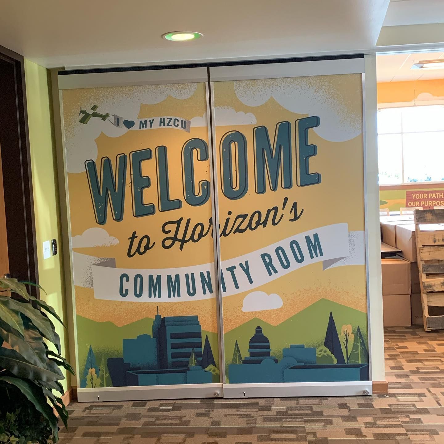 A large, colorful mural on double doors says 