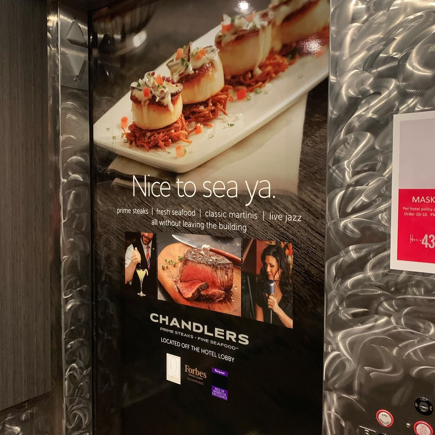 An advertisement for Chandlers restaurant featuring scallops and steak, with the text 