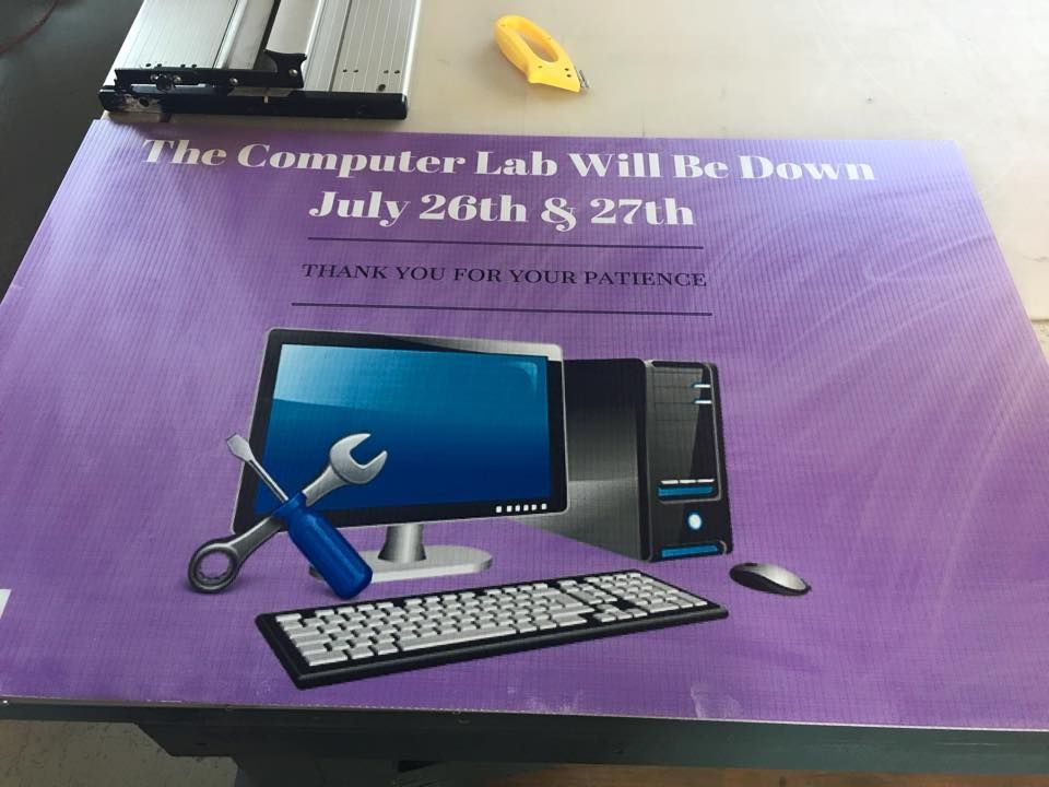 A purple sign reads, 