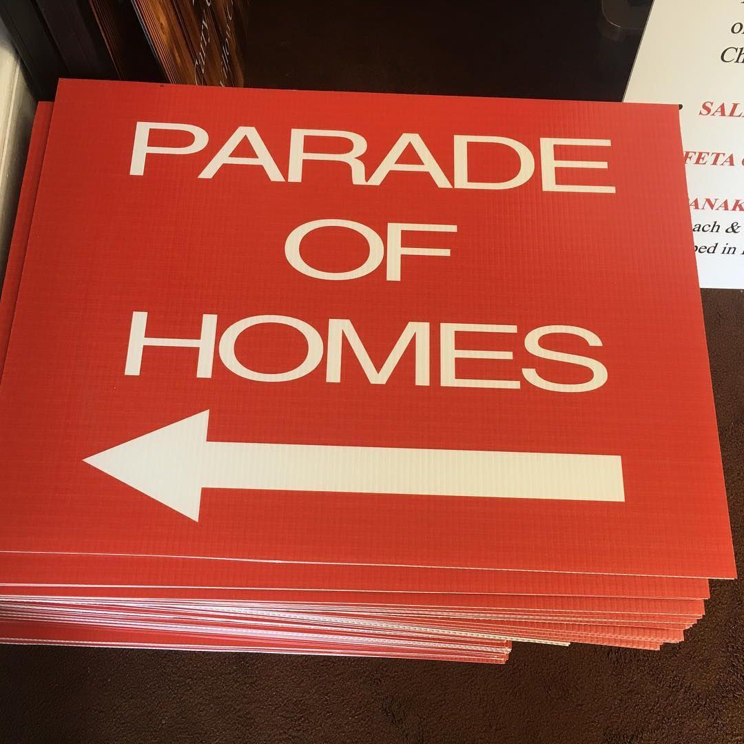 A stack of red directional signs reading 