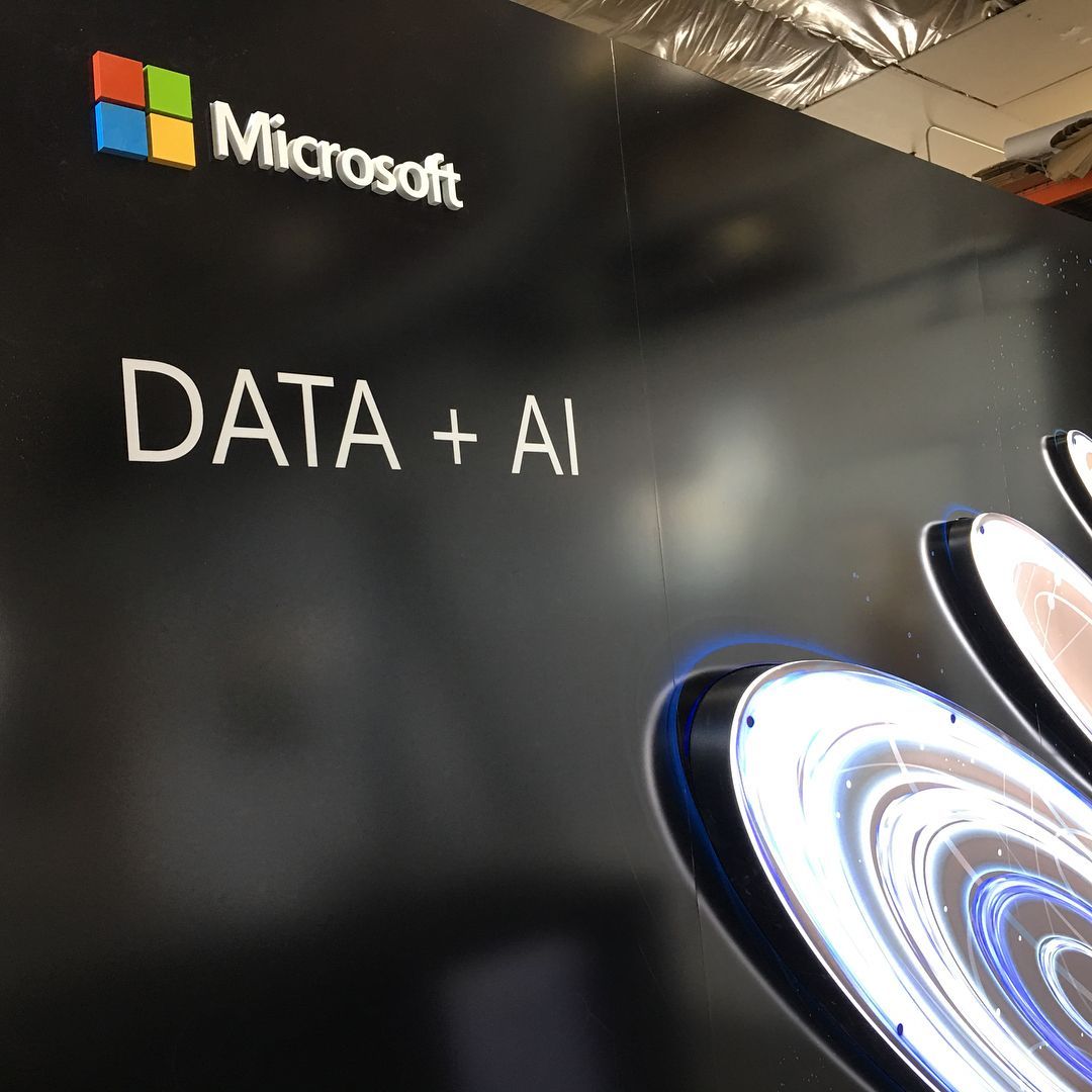 A black wall with the Microsoft logo and the text 