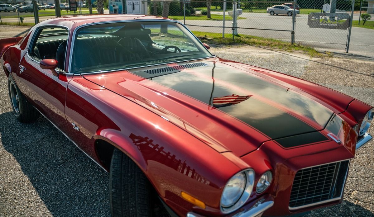 The front of a ceramic coated red Antique Corvette.