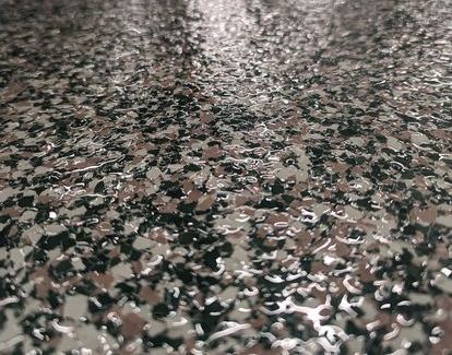 A close up of a concrete floor with a camouflage pattern.