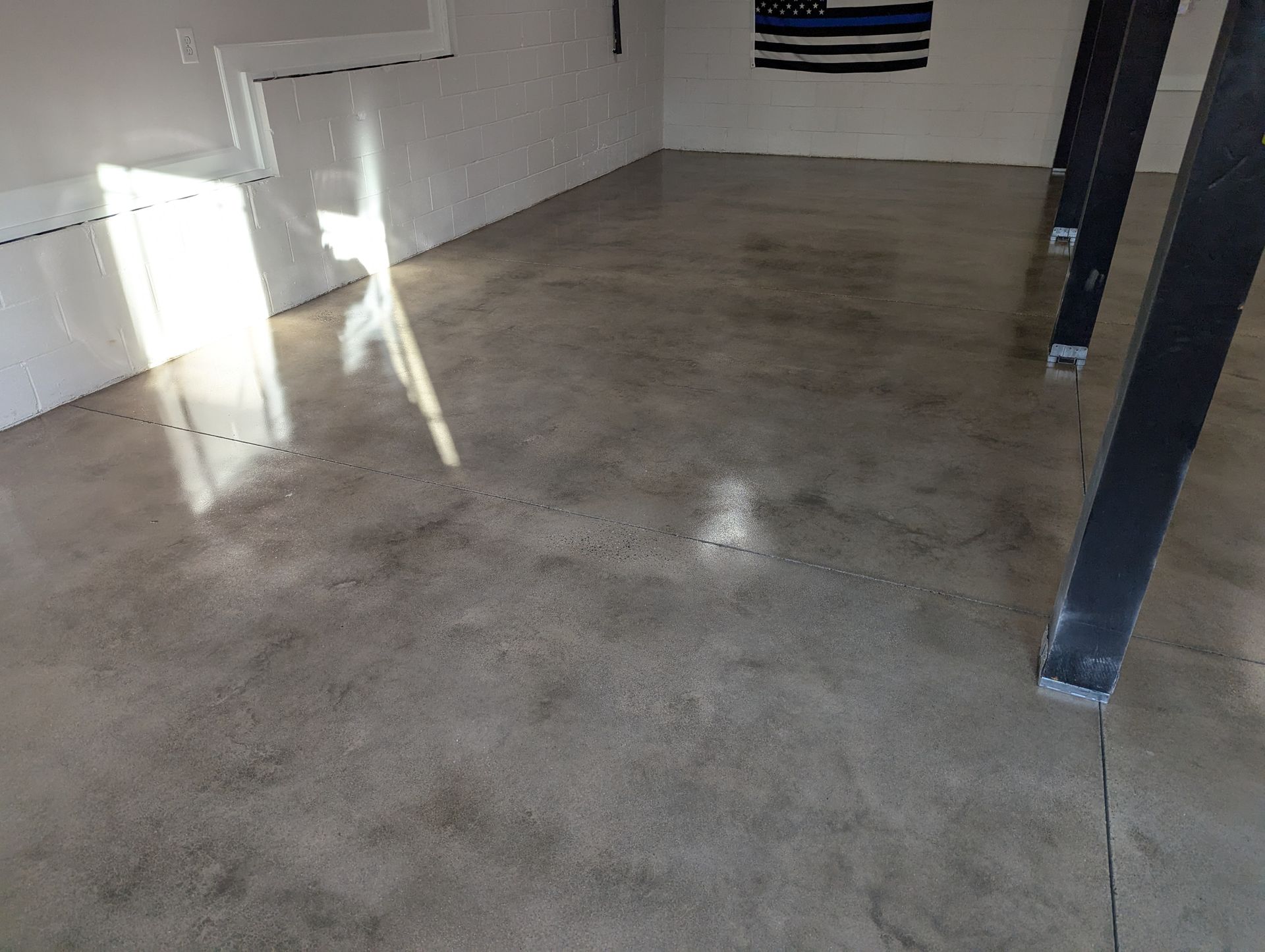 A garage floor with a brick wall in the background.