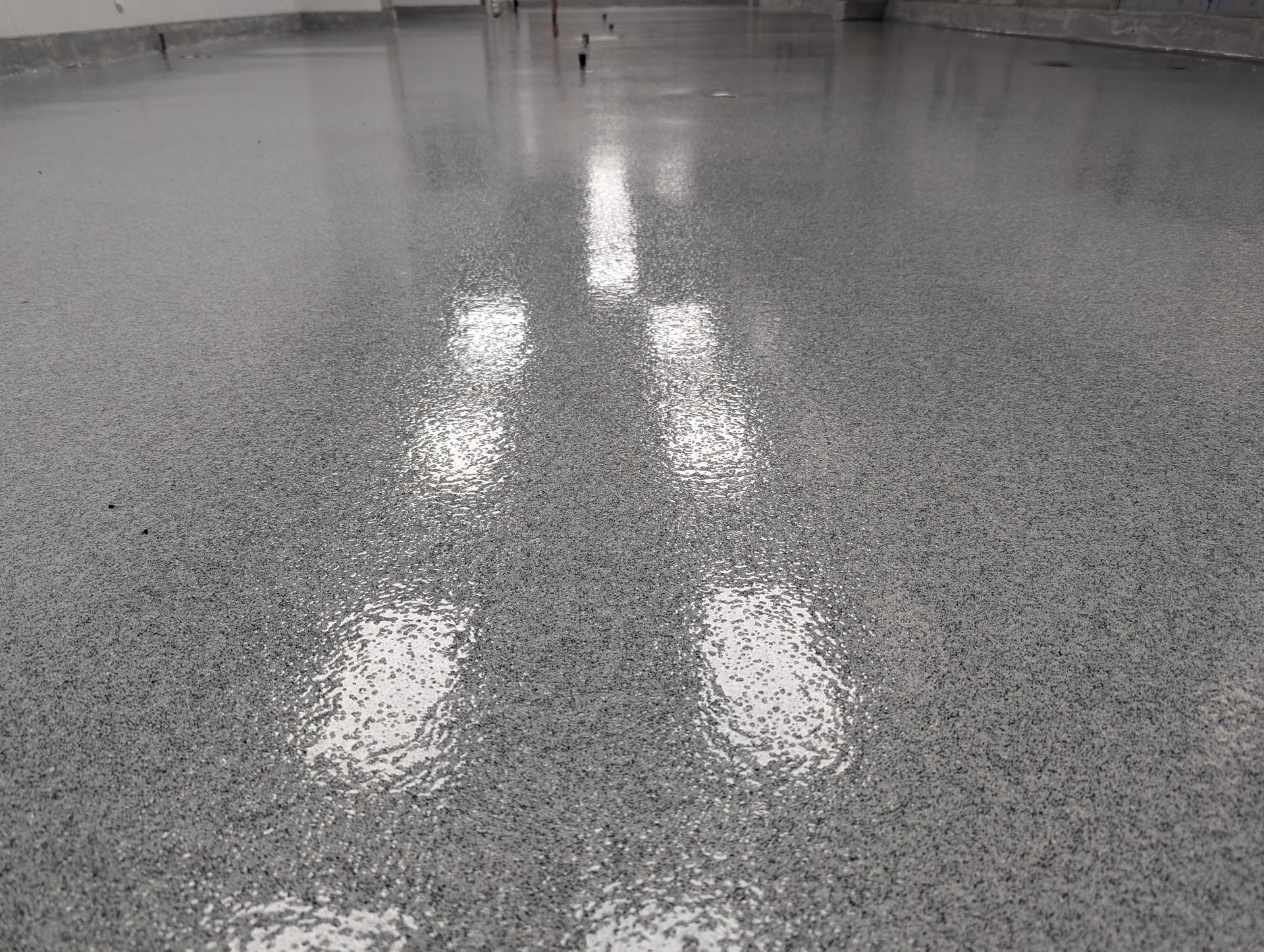 A close up of a shiny concrete floor in a room.