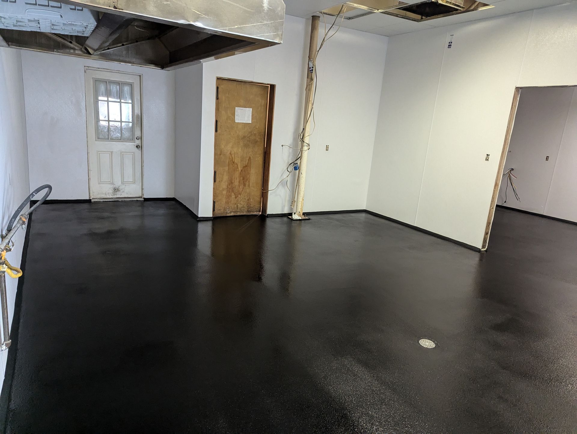 A large room with a white floor and a lot of windows