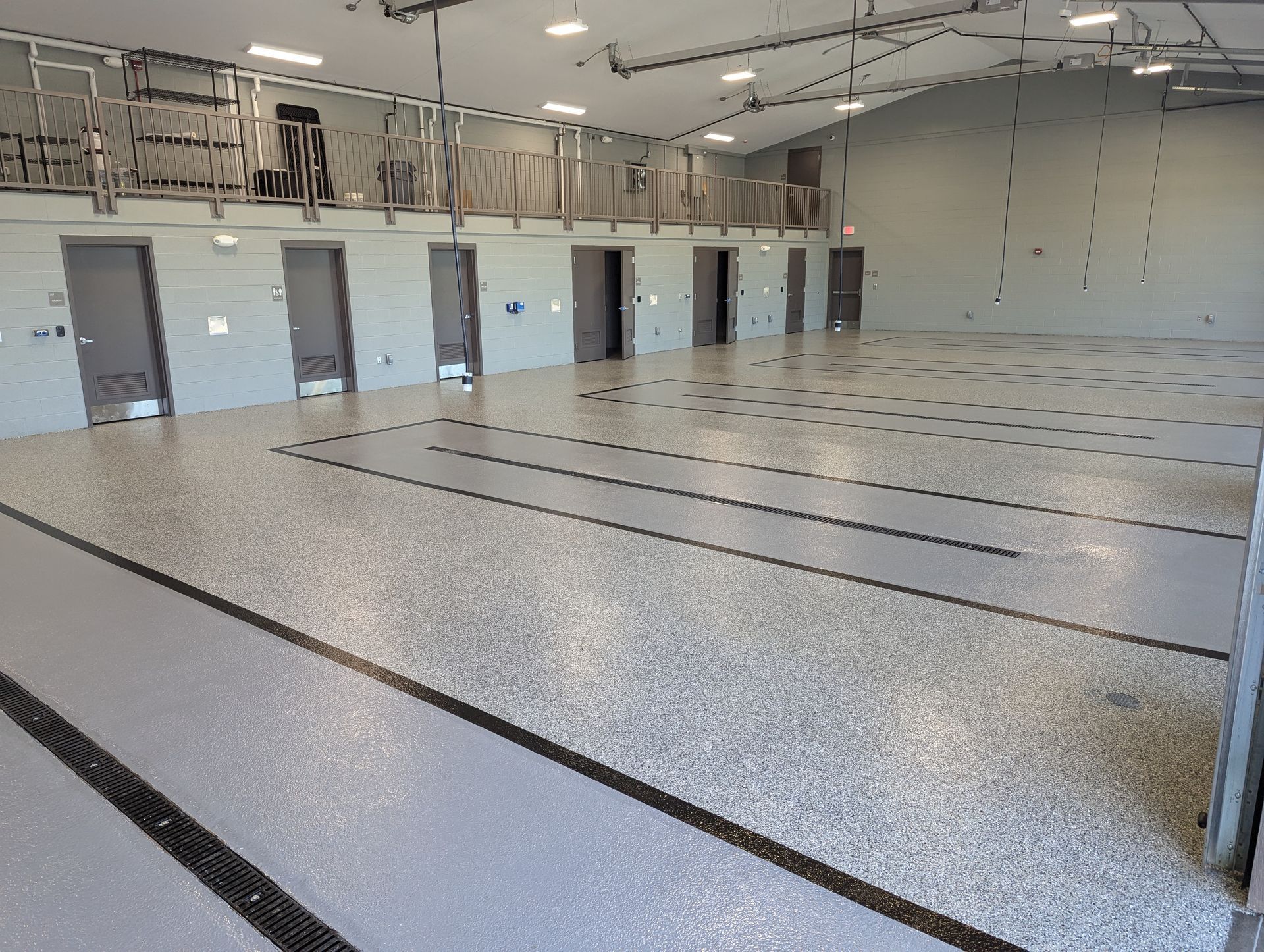 A large room with a lot of doors and a concrete floor
