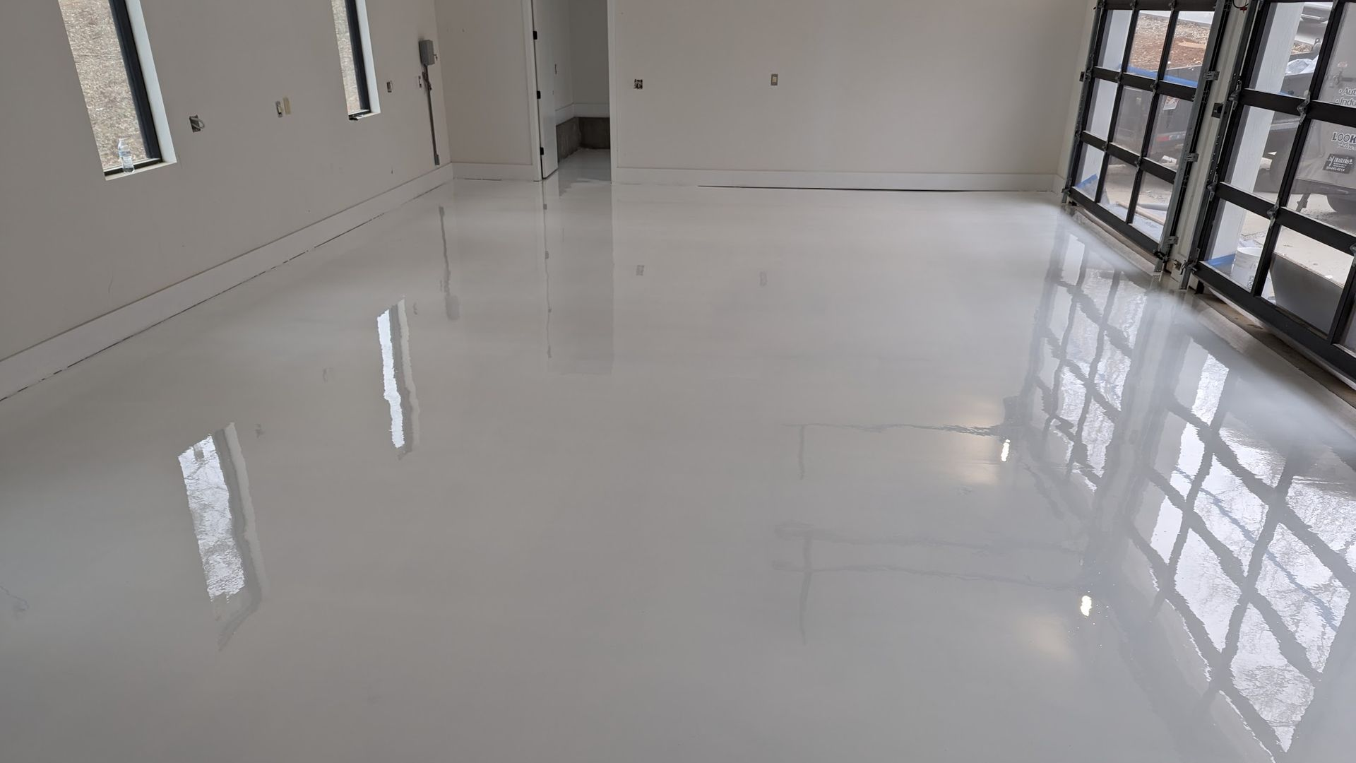 A large room with a white floor and a lot of windows
