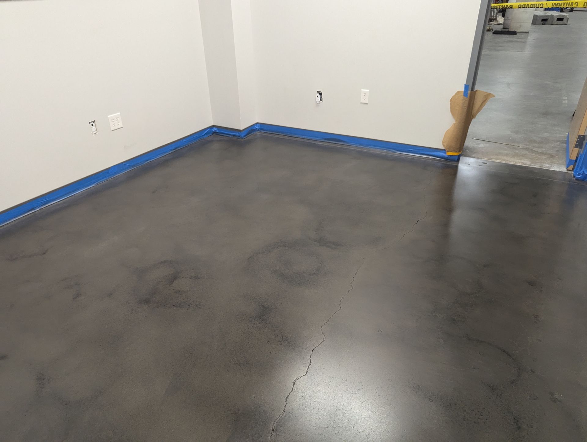 A room with a concrete floor and white walls.