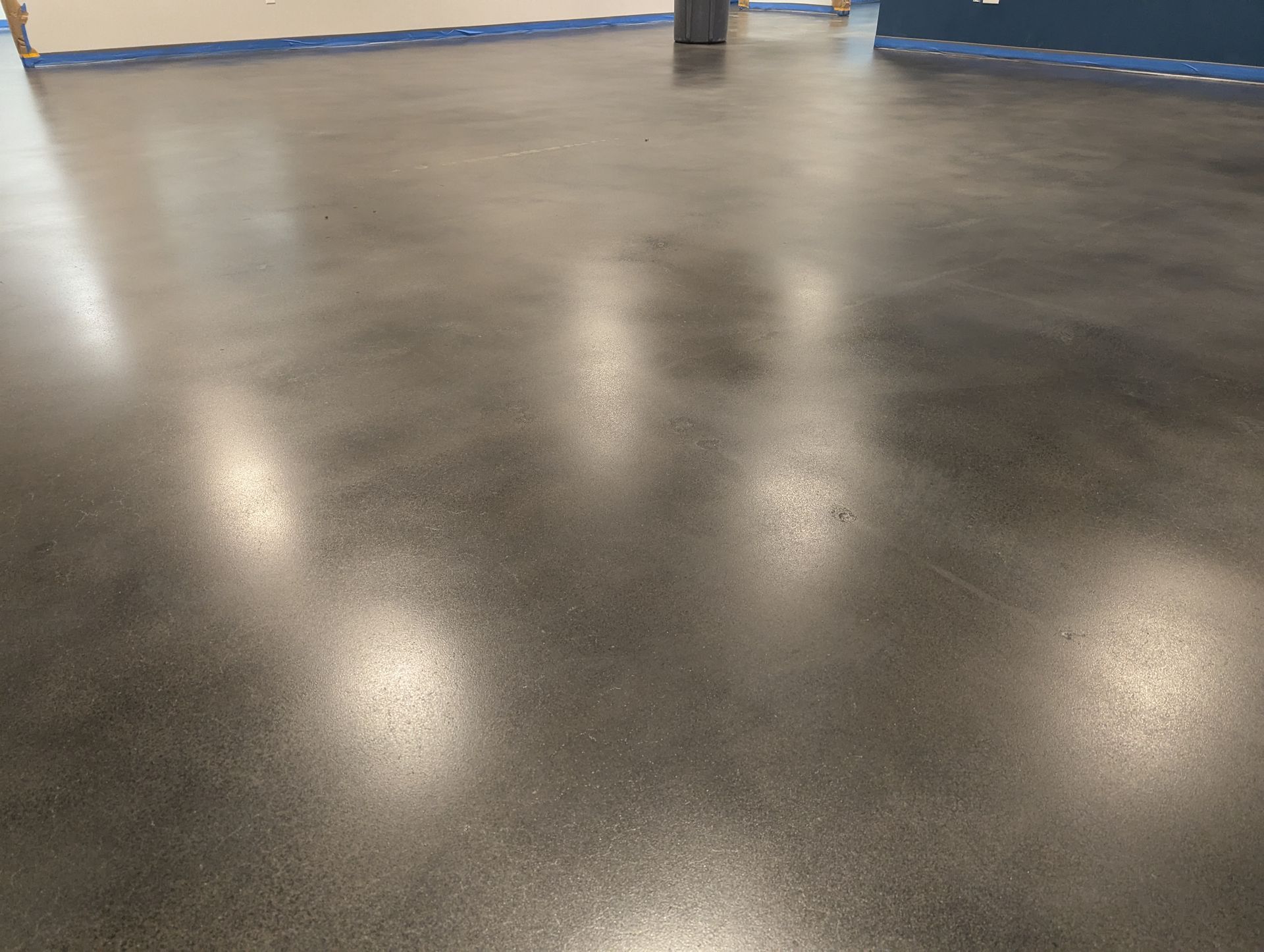 A close up of a shiny concrete floor in a room.