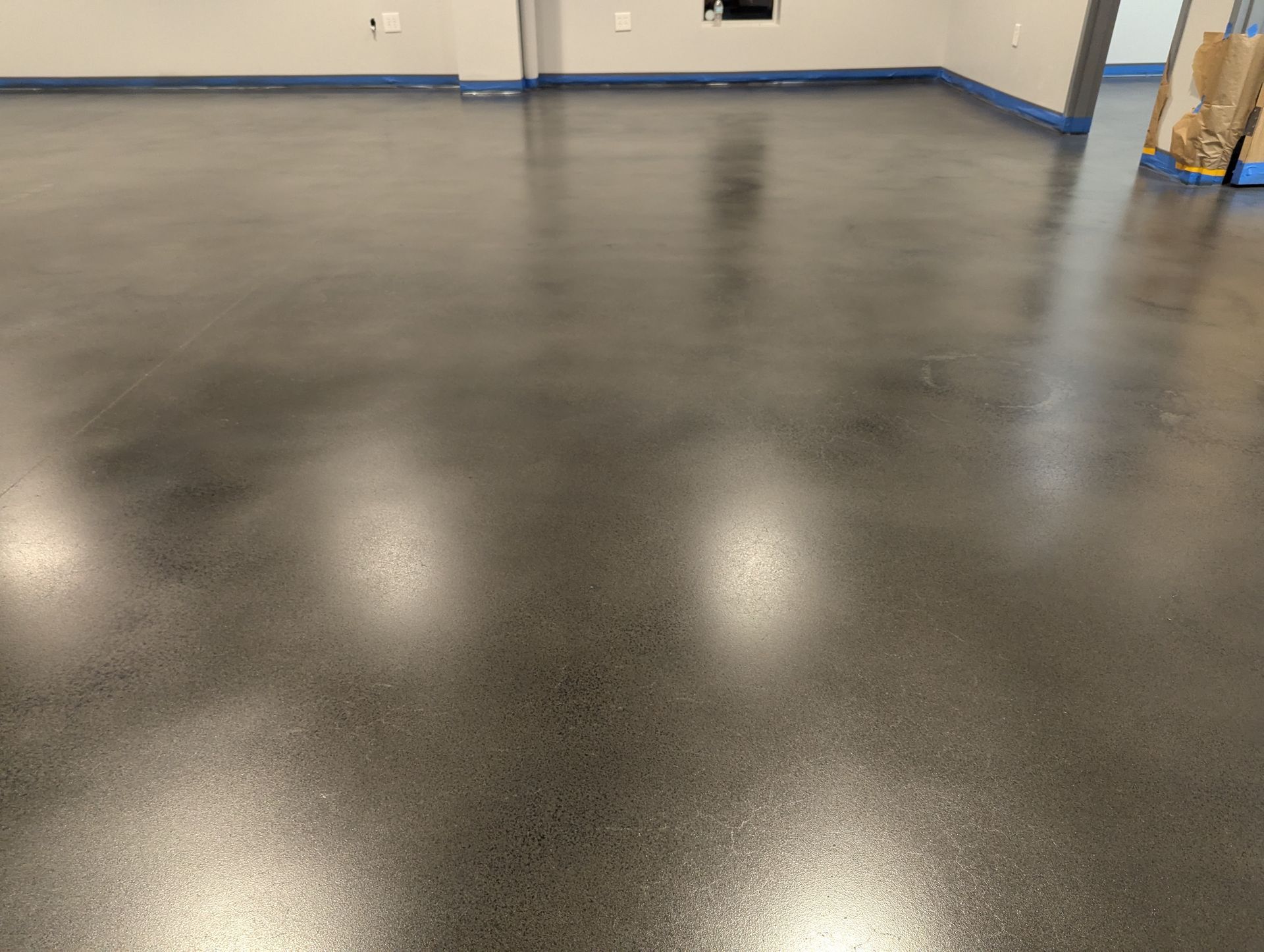 A shiny black concrete floor in a room.