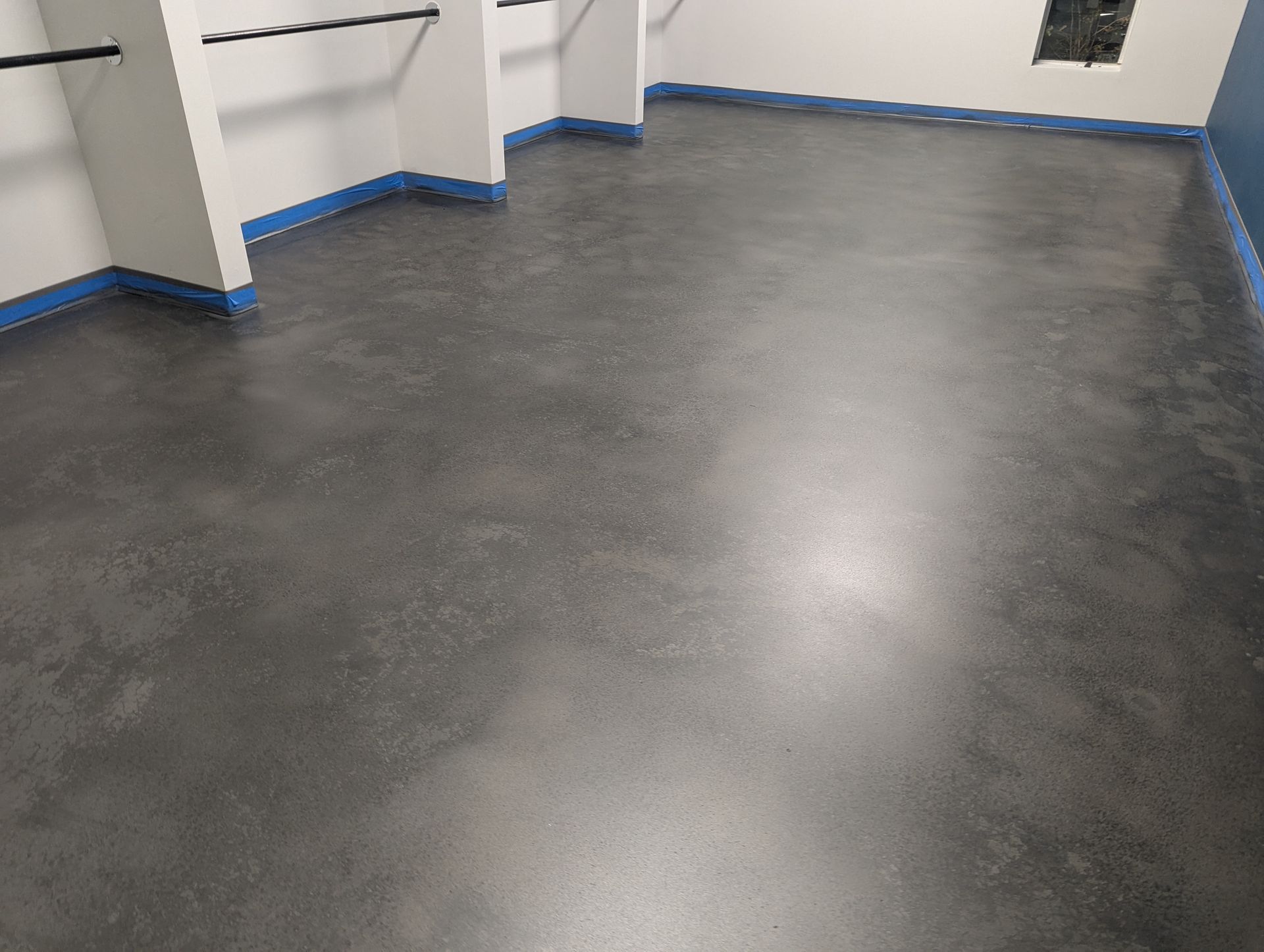 A shiny concrete floor in a room with windows