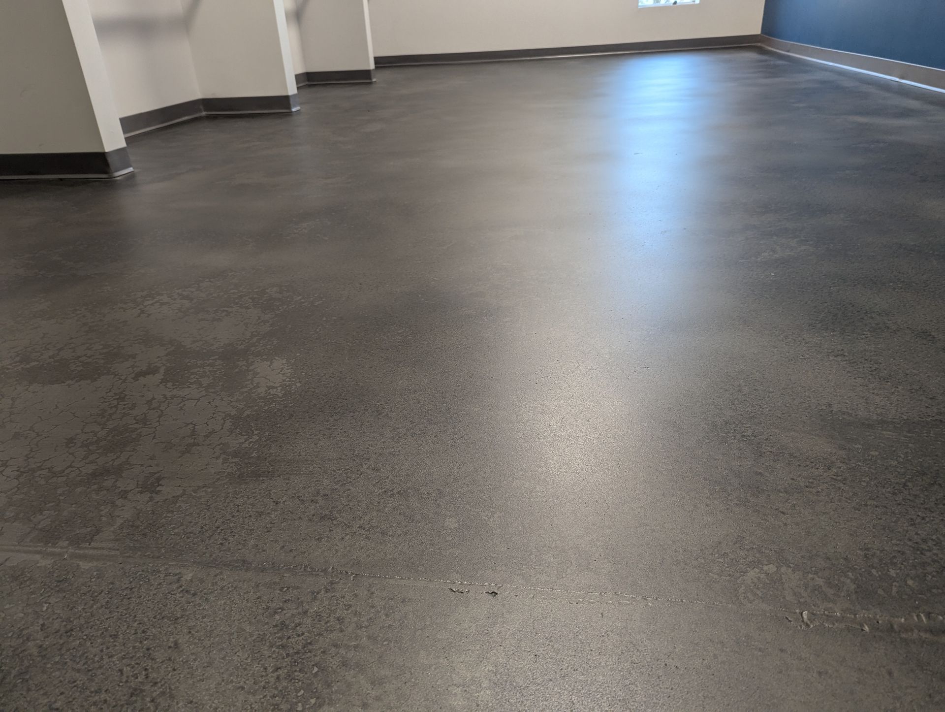 A room with a black floor and white walls.