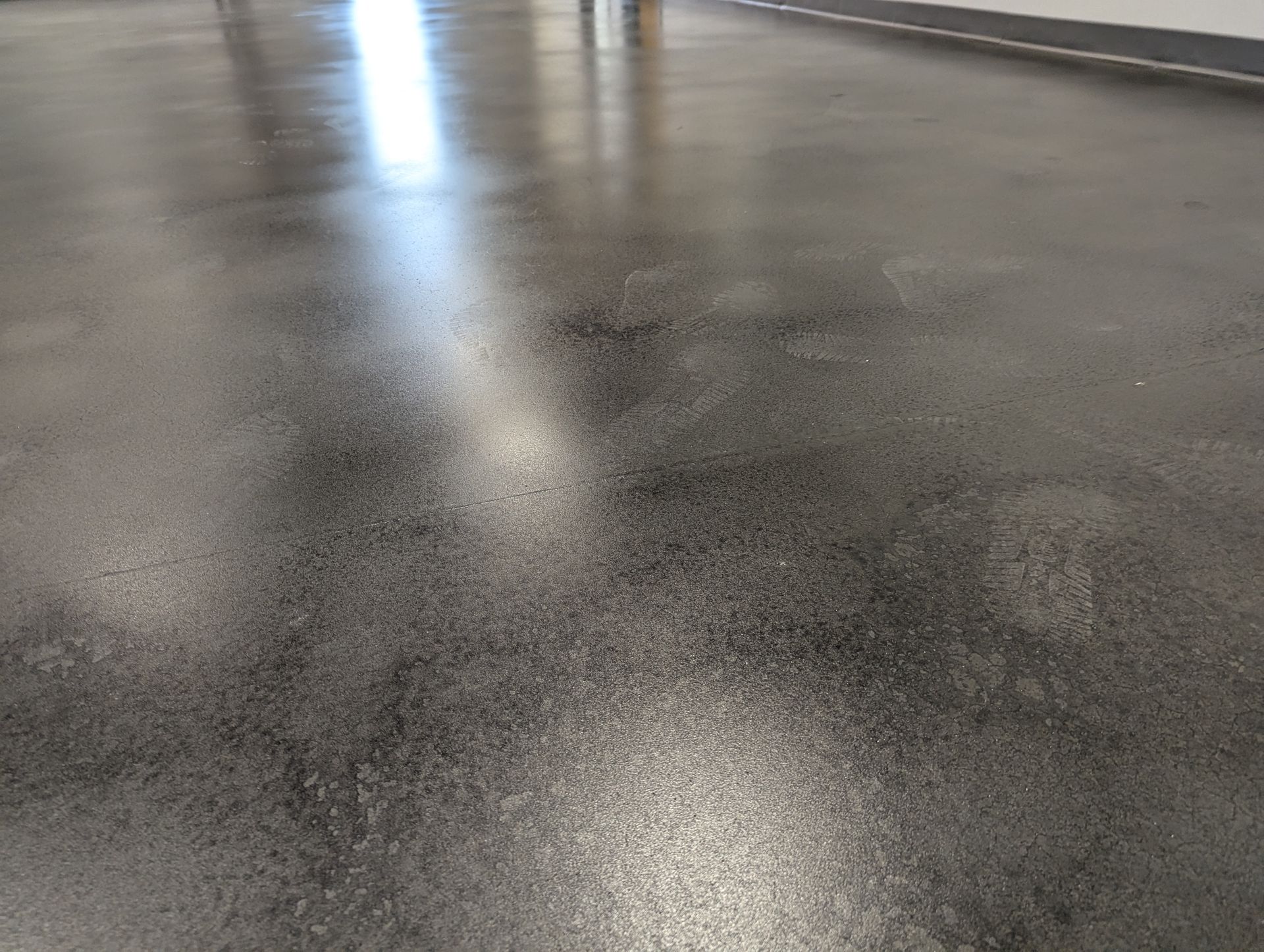 A close up of a shiny concrete floor in a room.