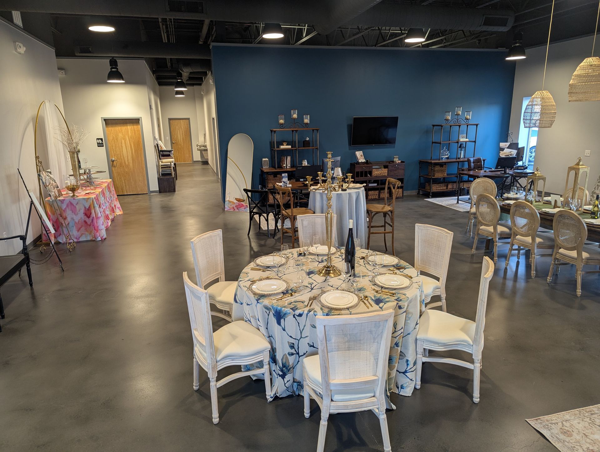 A large room with tables and chairs set up for a party.