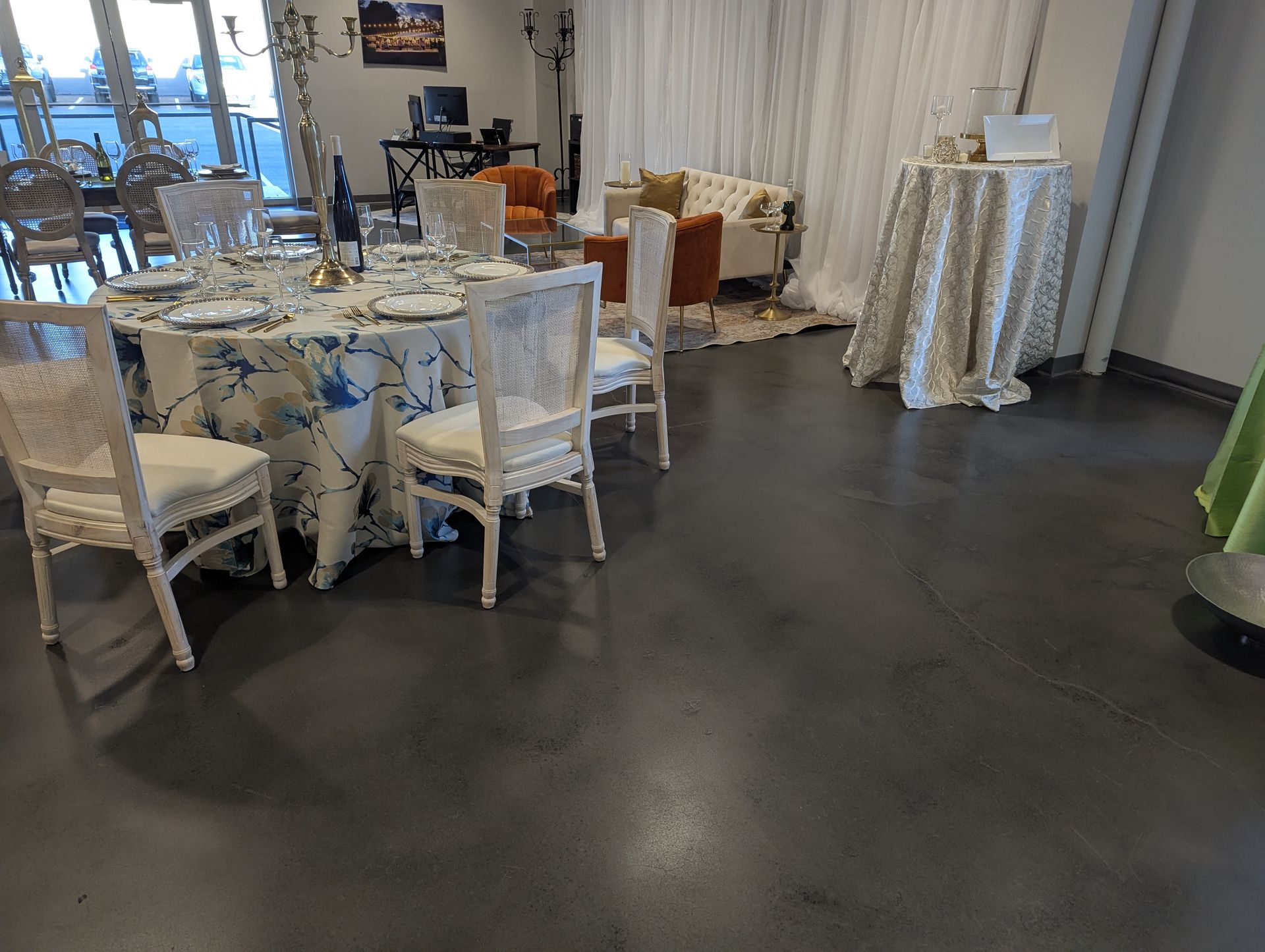A room with tables and chairs set up for a wedding reception.