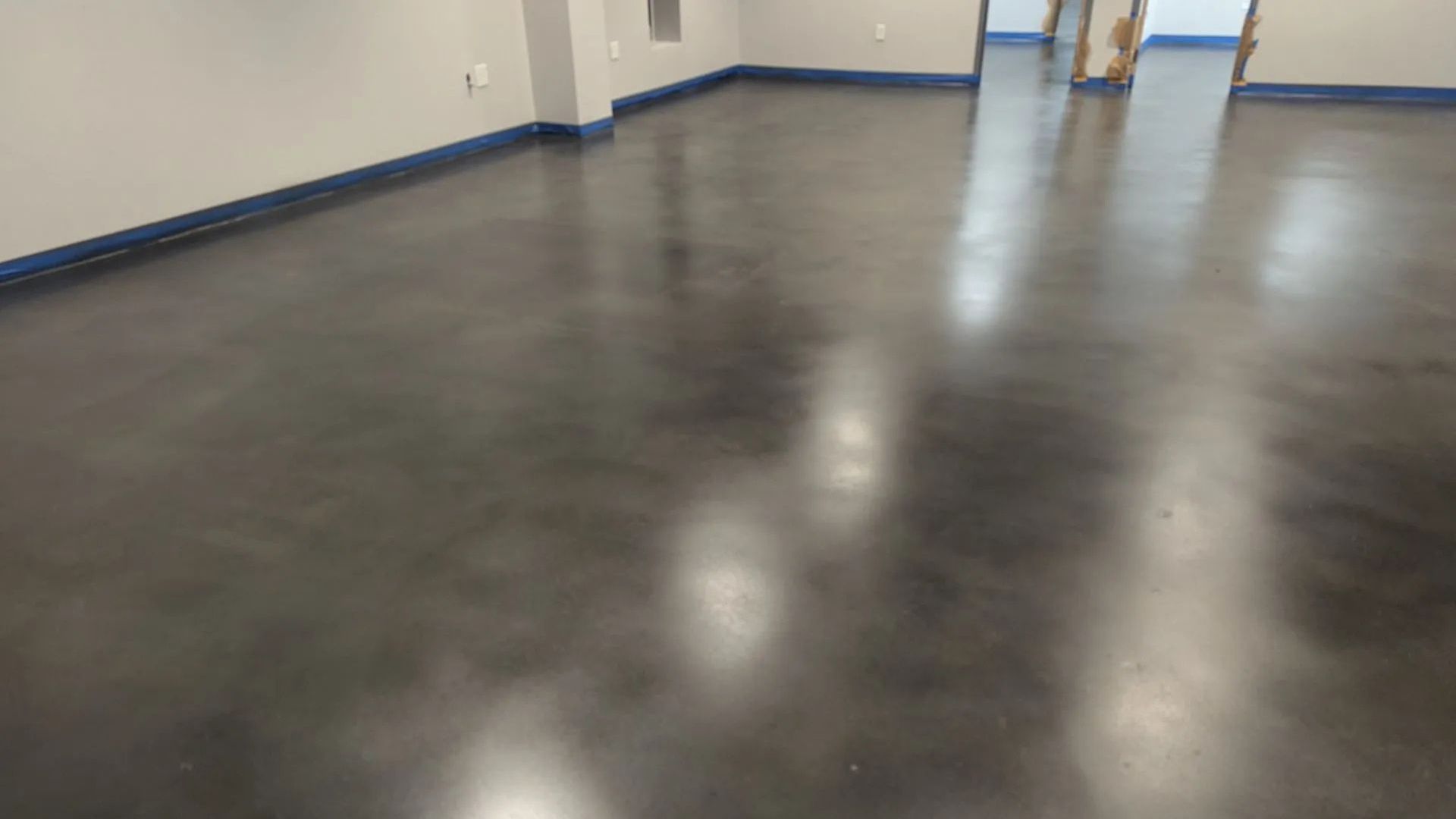 A large room with a white floor and a lot of windows