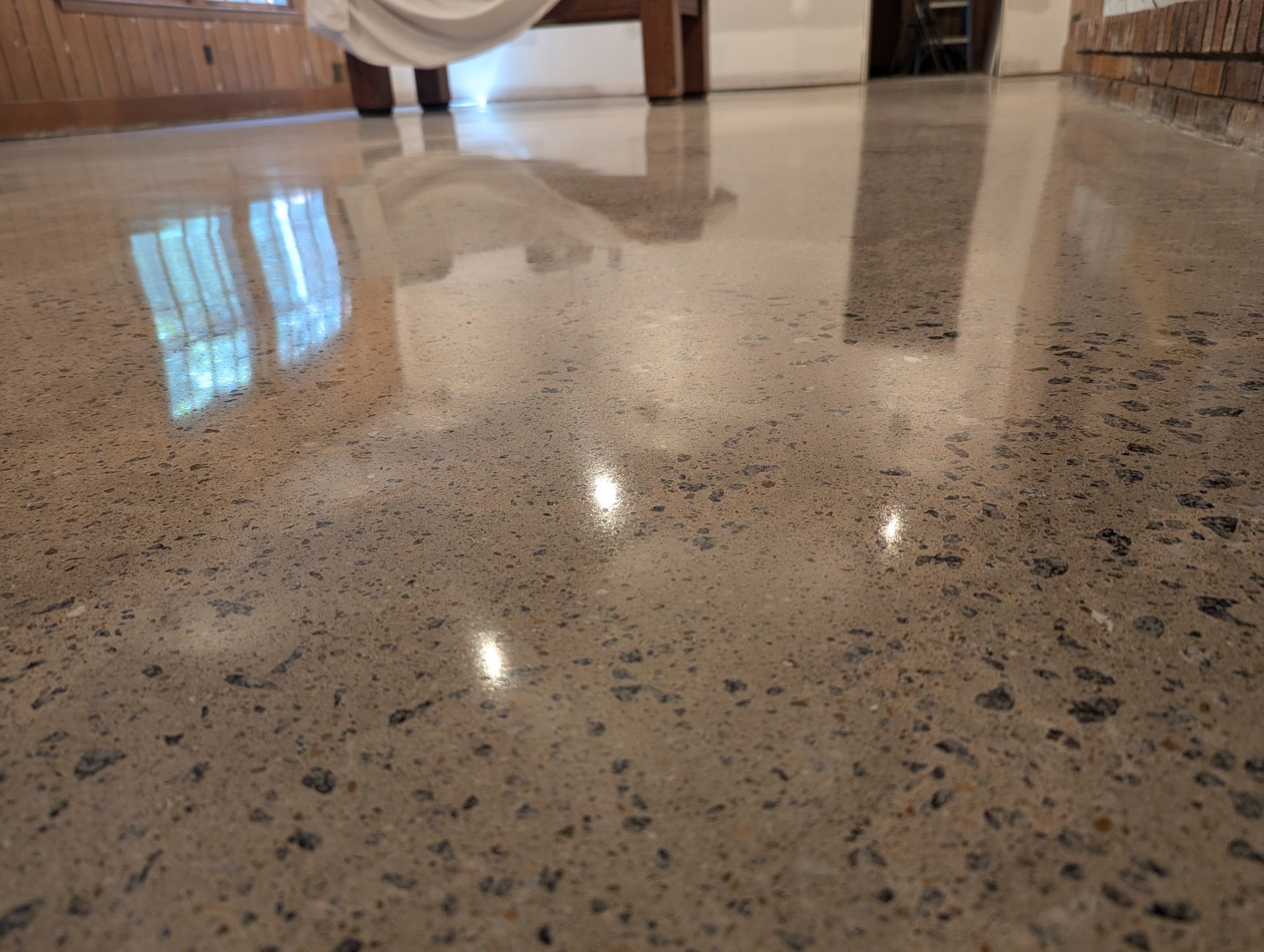 A close up of a shiny concrete floor in a room.