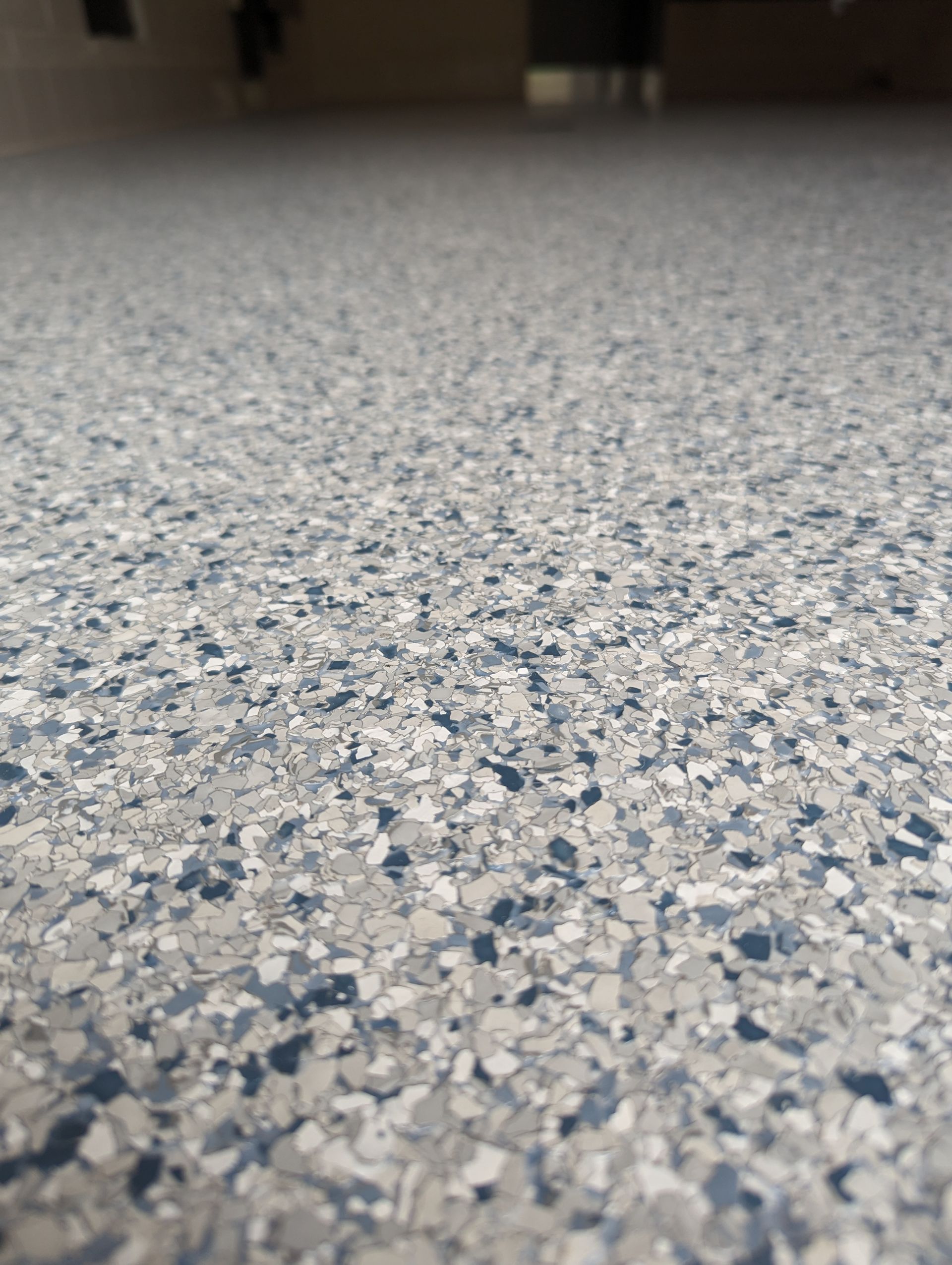 A close up of a shiny concrete floor in a garage.