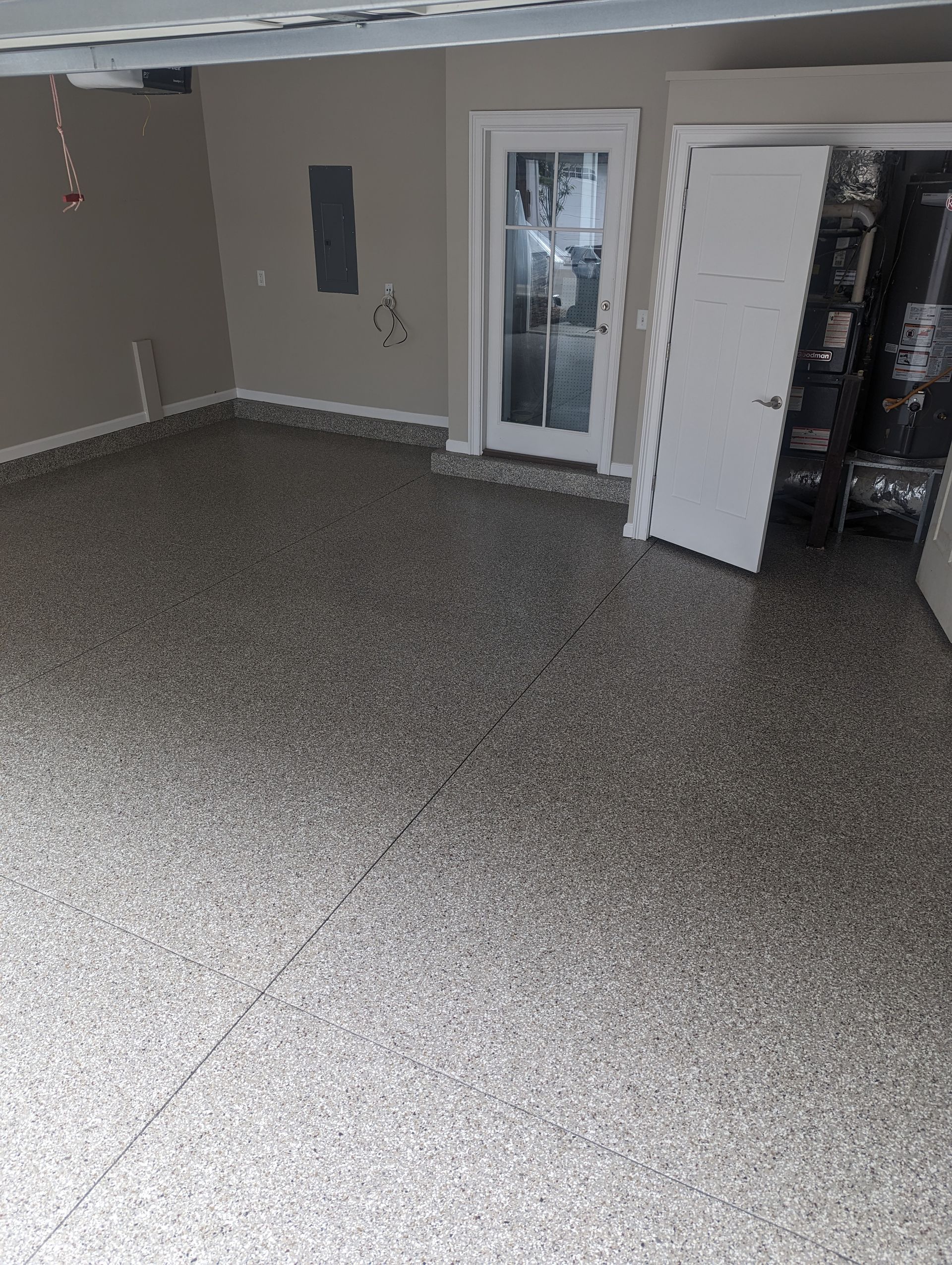 A garage with a concrete floor and a door.